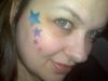 a girl with star tattoo on face